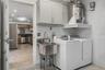 Garage laundry area with washer and dryer space and a utility sink for added convenience.