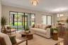Large sliding glass doors connect the living area to the screened lanai.