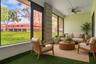 Sunroom with plenty of sunlight overlooking the green space.