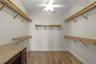 HUGE walk-in closet with built in vanity off of the Primary Bathroom