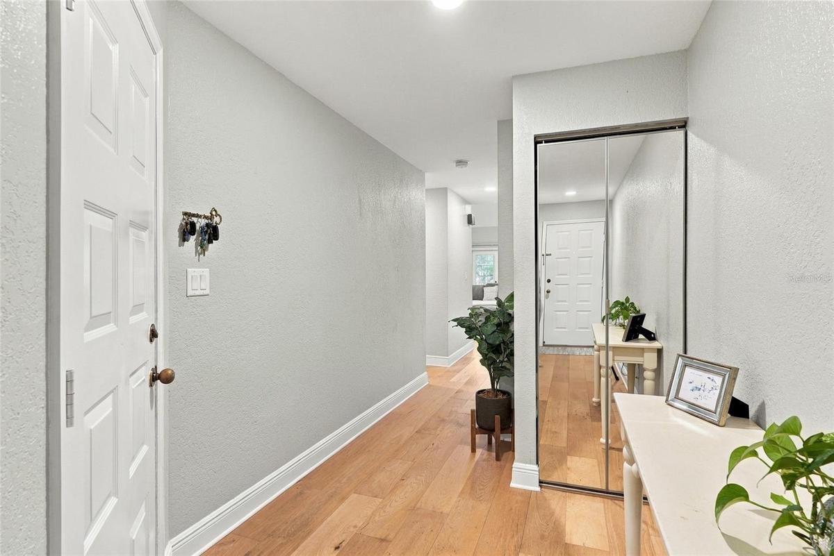 Front entryway with 3 storage closets and garage entry.