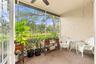 Enclosed lanai overlooking the pond—an inviting space for morning coffee, relaxing, or enjoying the surrounding wildlife.