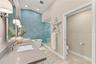 Quartz double vanity with soft-close shaker cabinetry offers plenty of space and storage for everyday living.