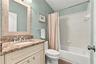 updated upstairs guest full bathroom with shower tub combo.