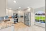 Beautifully updated kitchen featuring striking Norwegian Blue granite countertops and warm Alabama maple cabinetry.