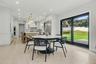 Eat-in-kitchen with sliding glass doors to backyard, Redone floors. And new black Anderson Windows.