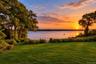 Private tennis court and gazebo overlooking the water