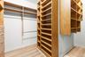 Large walk- in with custom built ins.  Plenty of drawers, hanging and shelves