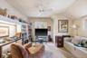 Sitting room featuring carpet flooring, plenty of natural light, and a ceiling fan