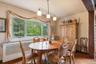 Dining area featuring light wood-type flooring, radiator, and a textured ceiling