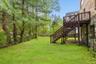 View of yard featuring stairs and a deck