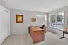 Spacious room with light gray walls, double door closet and recessed lighting.