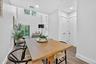 Dining room with wood finished floors, recessed lighting, and a high ceiling