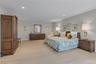 Spacious Primary bedroom featuring light-colored new carpeting and recessed lighting.