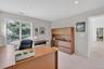 Recessed ceiling lighting, wood-finish built-in cabinetry, dual pane window, and light-toned wall paint