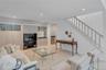 Recessed lighting illuminates this living space featuring a light wood-finish built-in cabinetry, mi