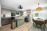 Light vinyl plank flooring, recessed lighting, and a sliding glass door