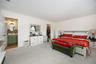 White paneled bed frame with dark hardware