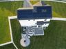 Rooftop solar panel array, composite deck, paver patio, integrated fire pit, and white vinyl perimeter fencing