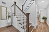 Stairway featuring wood finished floors and recessed lighting