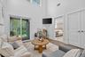 Living room with a towering ceiling and wood finished floors