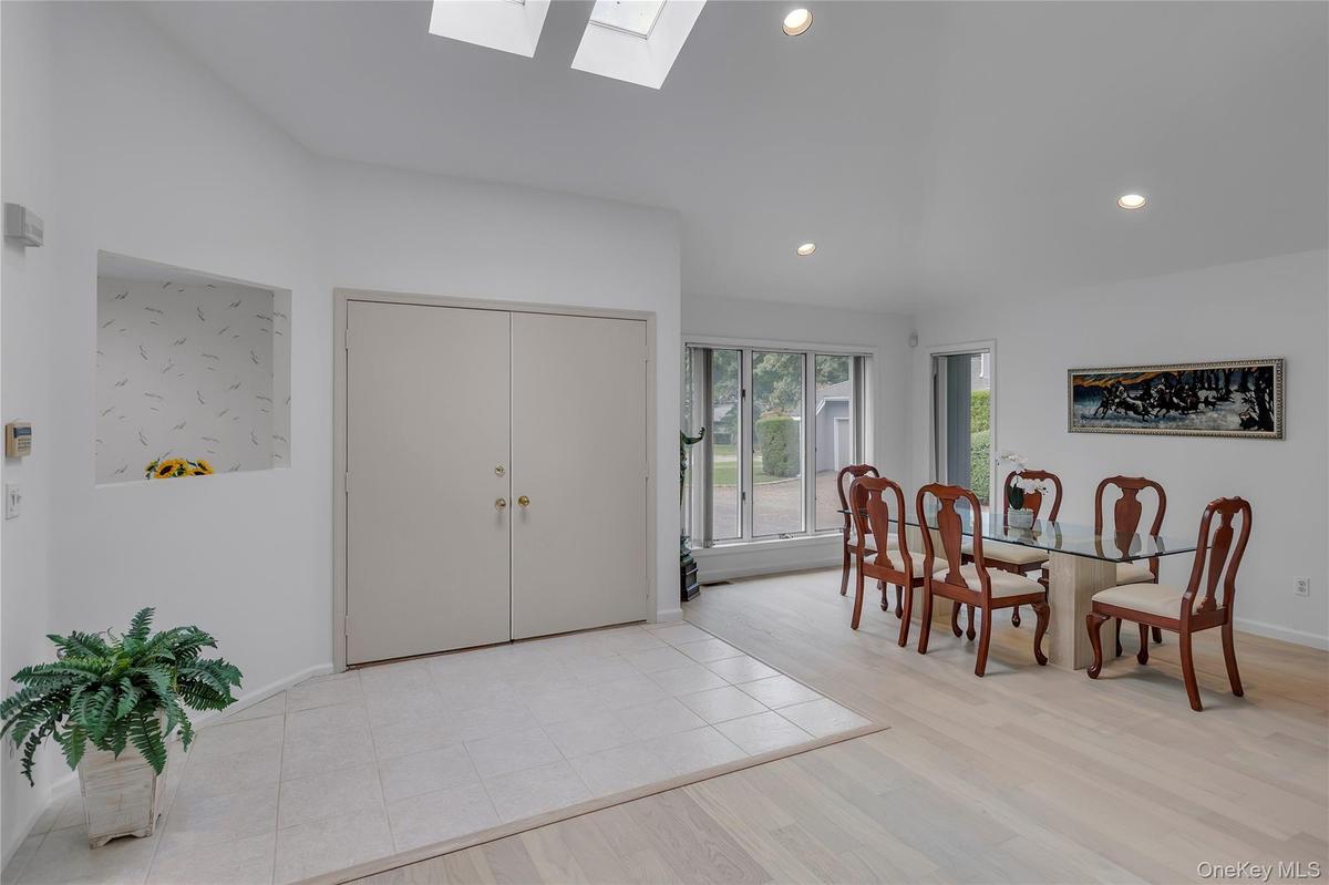 Two - story foyer featuring a vaulted ceiling with two skylights.