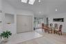 Two - story foyer featuring a vaulted ceiling with two skylights.