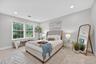 Bedroom with multiple windows, carpet floors, and recessed lighting