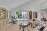 Spacious living area featuring a vaulted ceiling and recessed lighting.