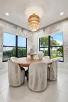 Bay windows with black frames, a tiered light fixture, and tile flooring