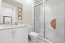 White vanity with an integrated sink, polished chrome faucet, and spacious countertop