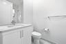 White vanity with an integrated sink, polished chrome faucet, and coordinating hardware