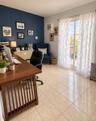 Expansive room featuring a two-tone paint scheme, large sliding glass doors, window-mounted air conditioning unit, and tiled flooring