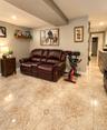 Recessed lighting, wood-finish wall shelving, and tile flooring with accent inserts