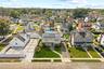Well-maintained lawn, solar panels, and extensive concrete paving