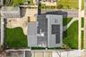 Roofline featuring multiple solar panel arrays and a skylight