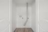 Laundry area with wood-finish flooring and white paneled doors