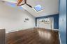 Vaulted ceiling featuring exposed wood beams and a ceiling fan