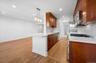 Beautifully designed kitchen also boasts a custom pantry closet.