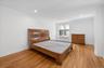 Spacious primary bedroom with recessed lighting