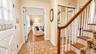 The welcoming foyer features tile flooring, a convenient coat closet, and easy access to the spacious living room, family room, and secondary bedroom 