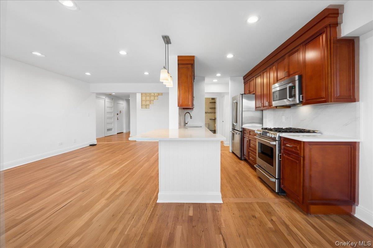 Dining area is open to living room and kitchen with sitting island.