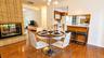 The inviting eat-in kitchen features a cozy wood-burning fireplace, convenient access to the kitchen, and sliding glass doors leading to the backyard,