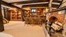The finished lower level is enhanced by a beautiful accent fireplace with a custom mantle, creating a warm and inviting focal point for relaxing and e