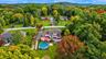 A stunning aerial view showcases this spectacular property surrounded by lush natural beauty and tucked away on a peaceful private dead-end street, of