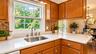 Enjoy abundant countertop space, plenty of natural light, and beautiful views overlooking your spectacular backyard oasis—perfect for cooking, gatheri