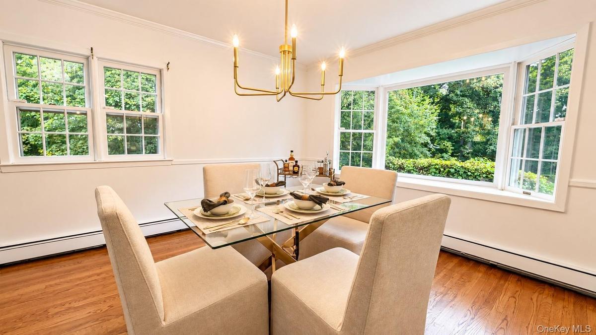 This inviting dining area is bathed in natural light, with walls of windows offering beautiful views and a seamless connection to the surrounding natu