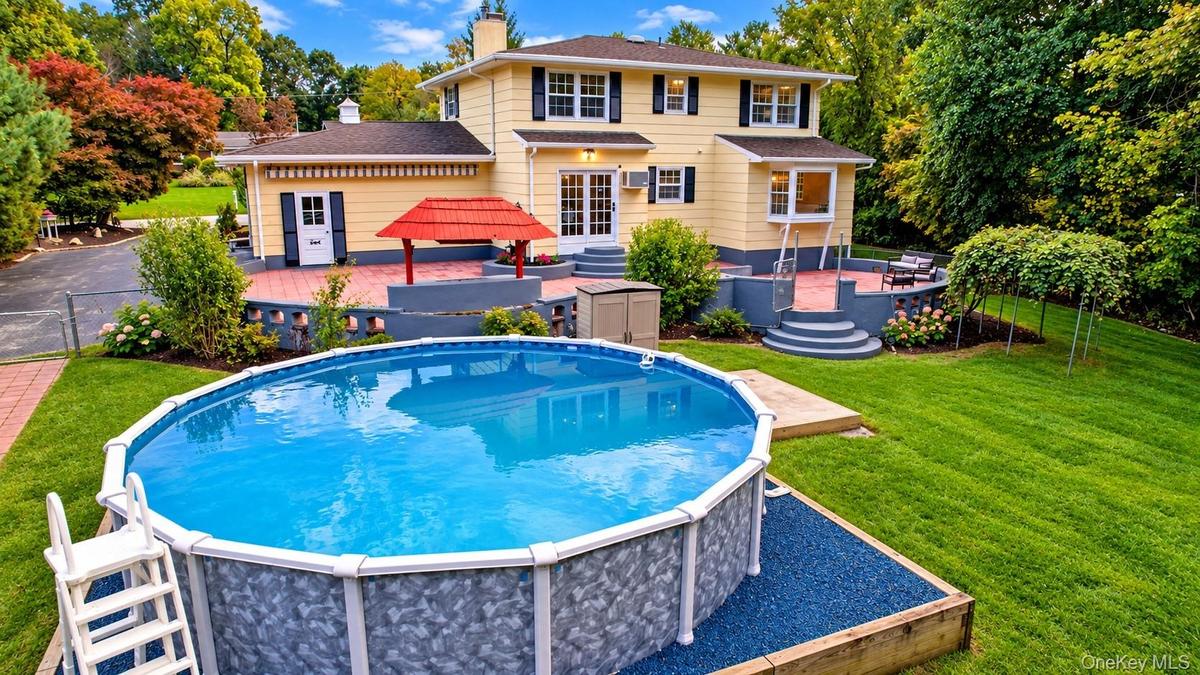 Nestled on over 1.2 acres, this property offers a private backyard oasis featuring a level, expansive fenced in yard, spacious patio, and above-ground