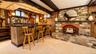 The walk-out lower level is an entertainer’s dream, featuring a gorgeous pub-style bar with custom built-ins and plenty of space to gather, unwind, la