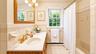 The spacious hallway full bath features a convenient tub and shower combination, offering comfort and functionality.